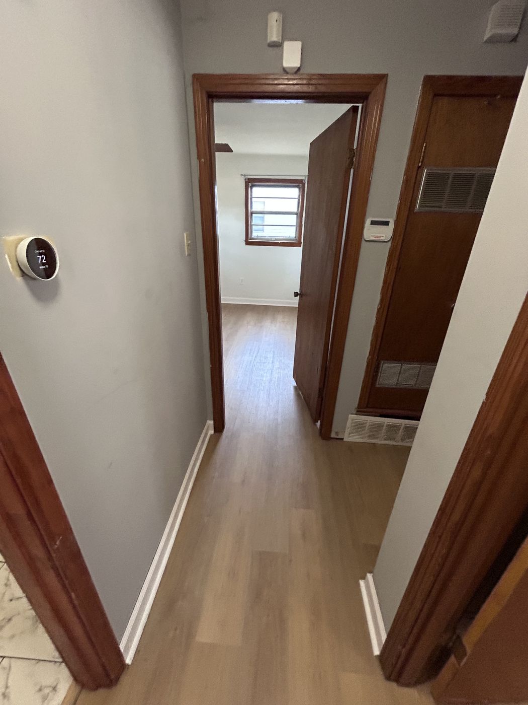 Hallway with light brown plank-style flooring